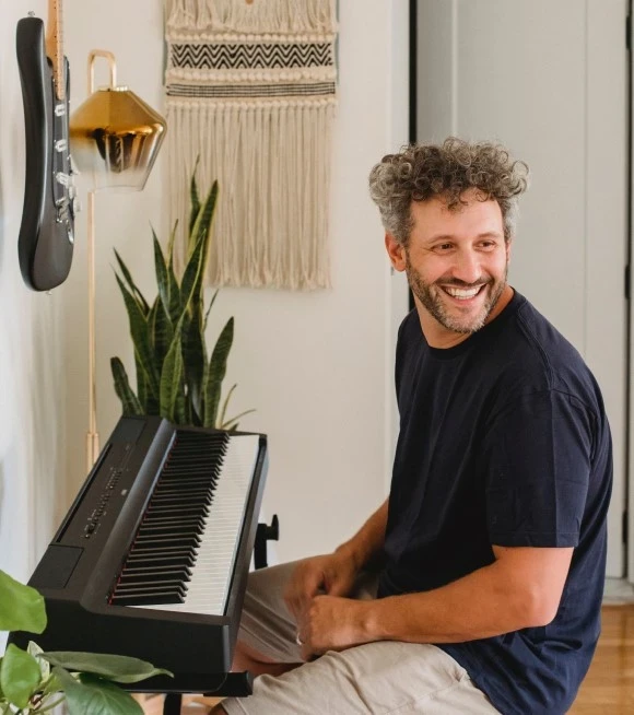 Man at piano smiling